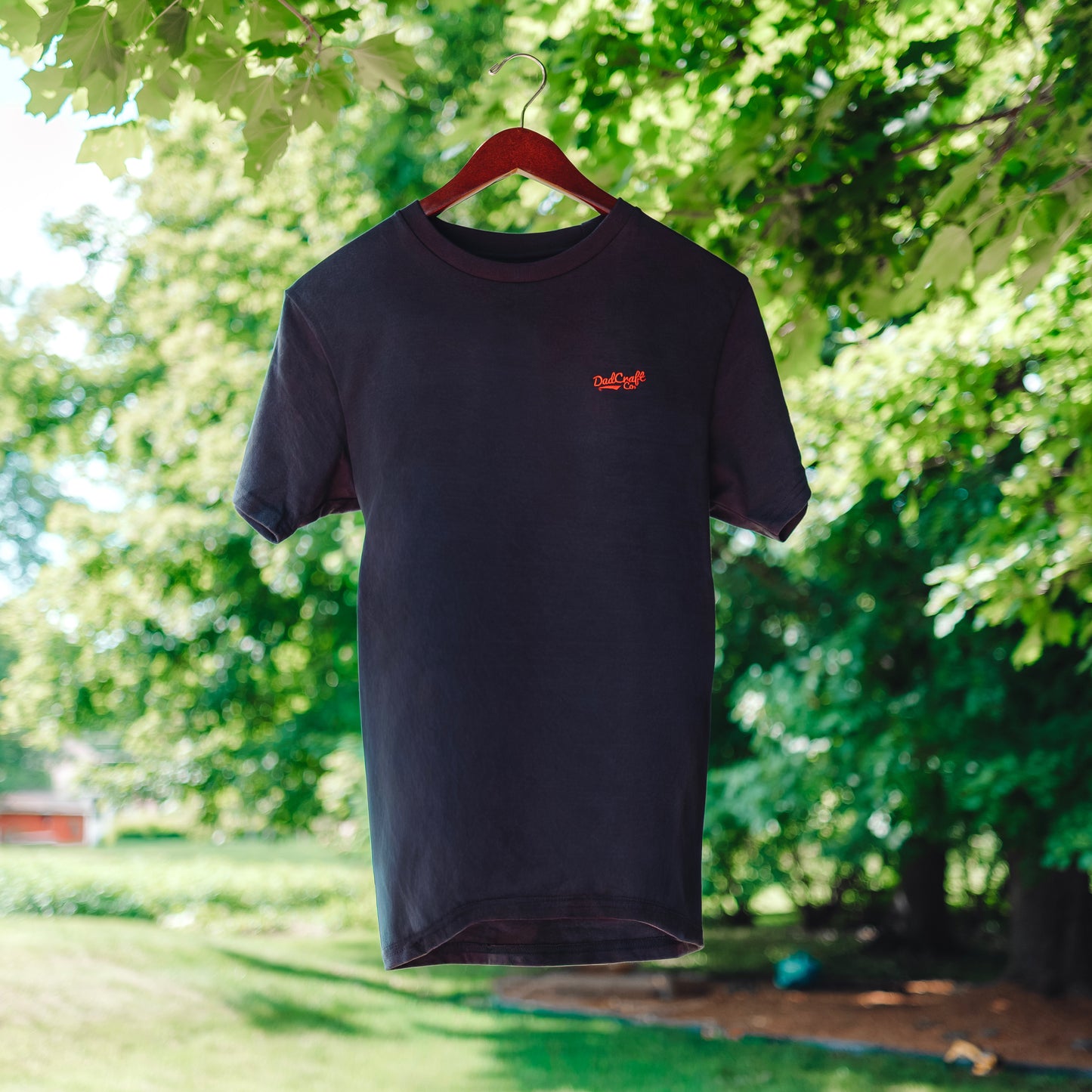 A Navy Blue T-Shirt with a small red DadCraft logo embroidered on the left chest