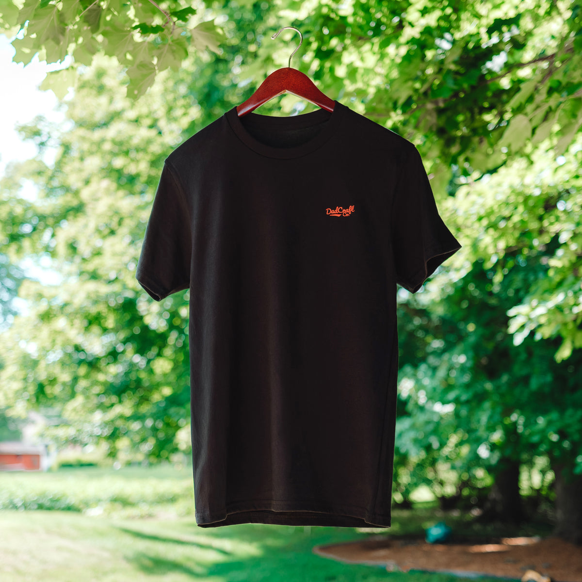 A Black T-Shirt with a small red DadCraft logo embroidered on the left chest